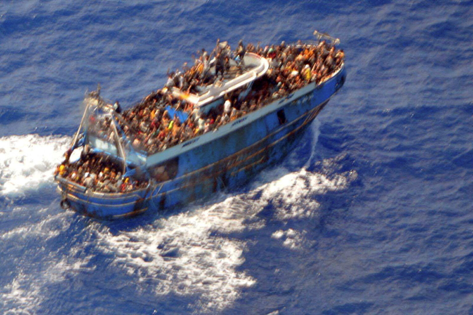 An undated handout photo provided by the Hellenic Coast Guard shows migrants onboard a boat during a rescue operation, before their boat capsized on the open sea, off Greece